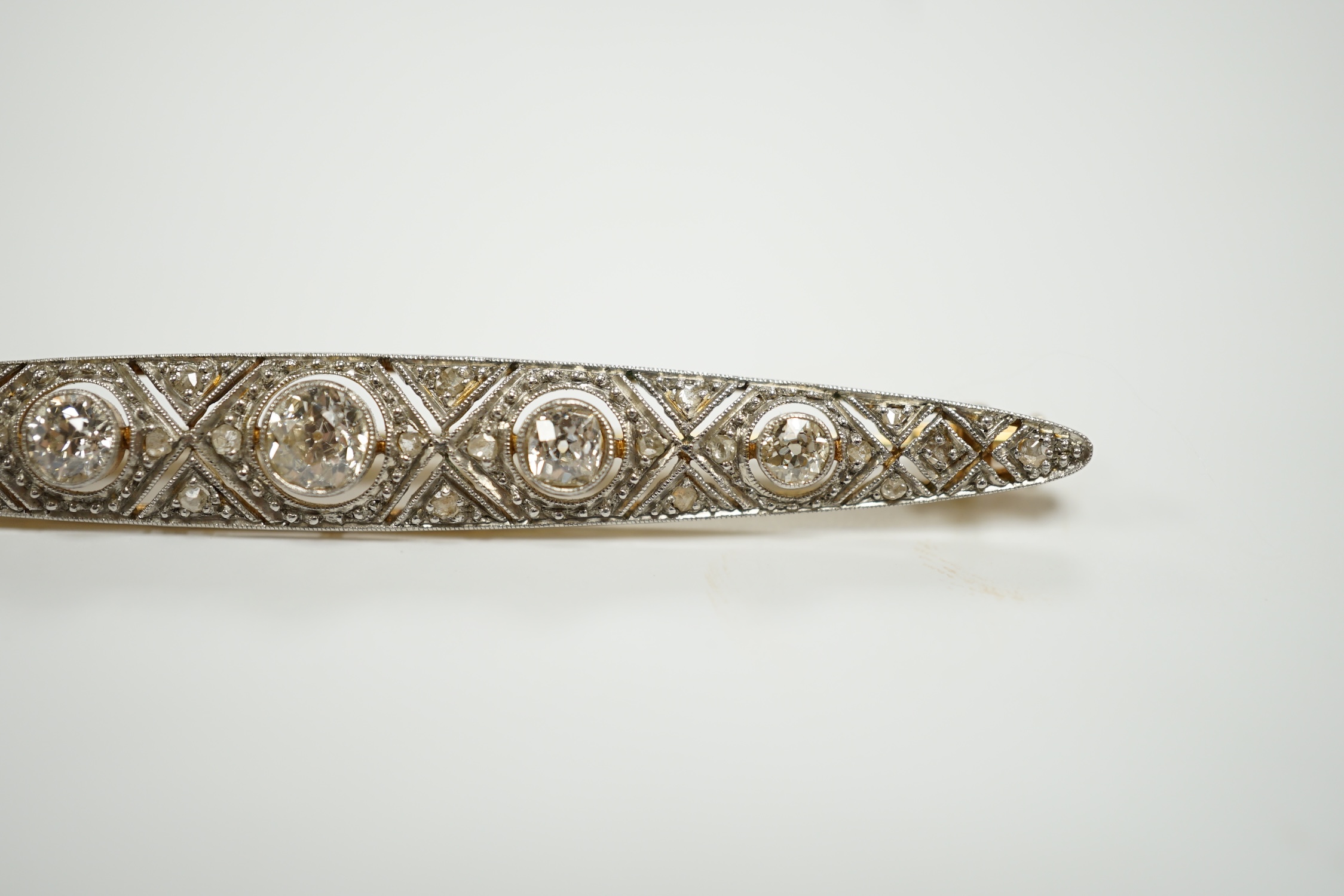 A Belle Epoque yellow and white metal mounted diamond cluster set navette shaped bar brooch, 69mm, gross weight 6.5 grams.